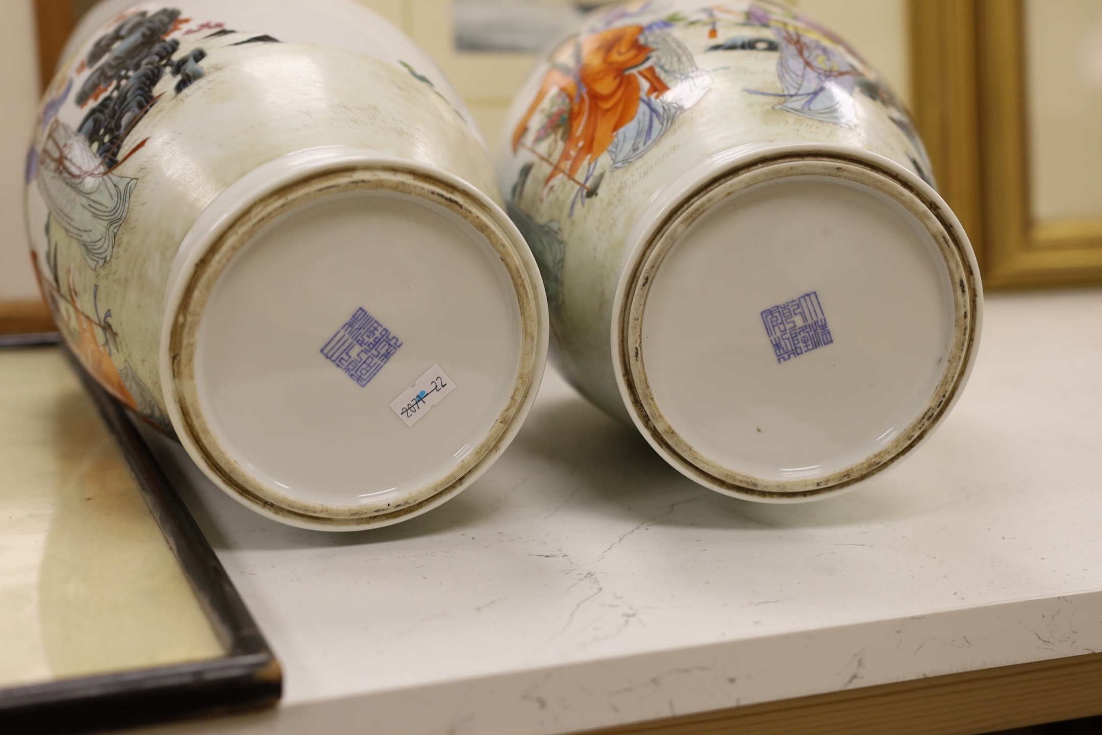 A pair of Chinese famille rose vases, 40 cms high.